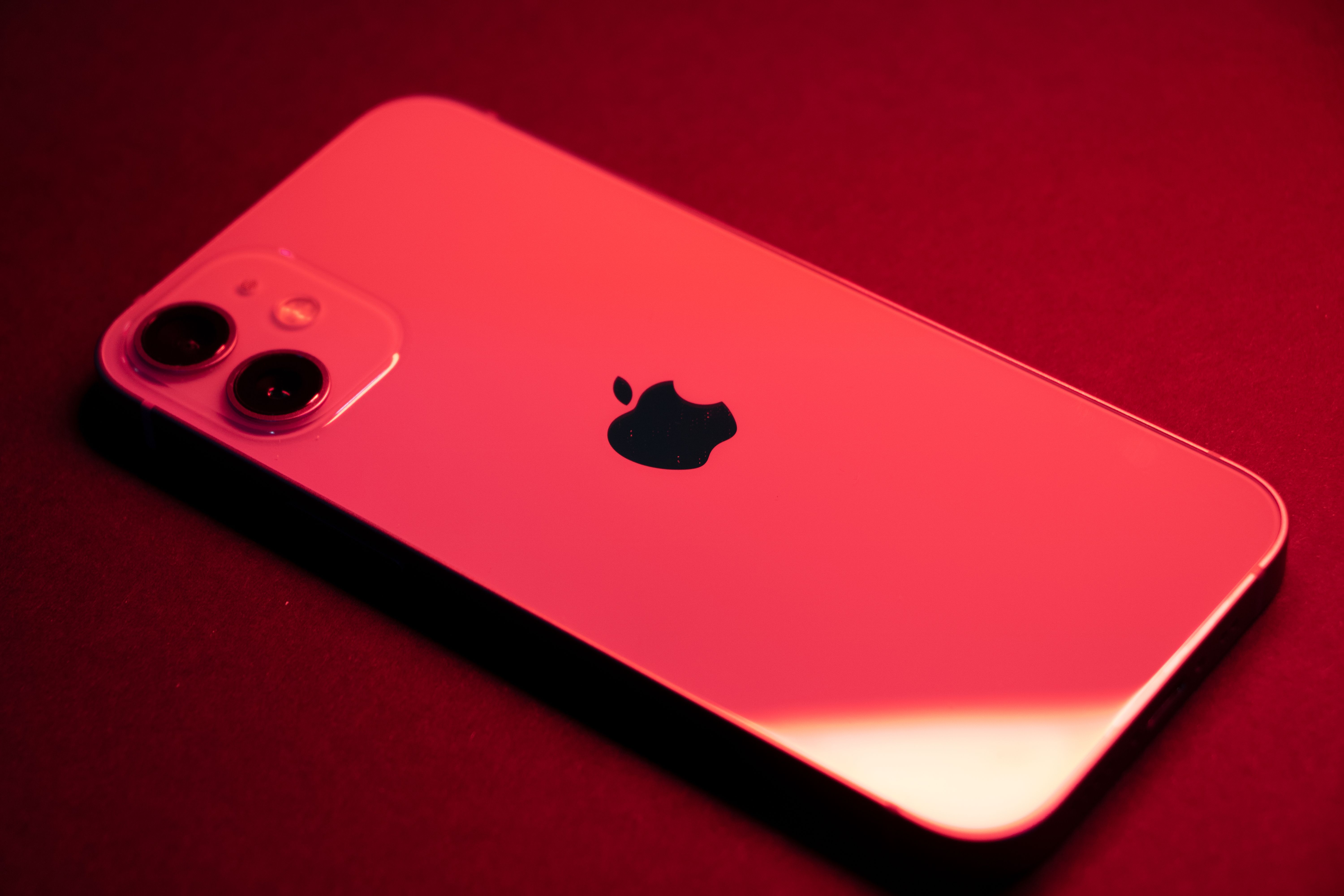 An iPhone lit in blue, representing the blue-bubble iMessage experience businesses want from an iMessage API